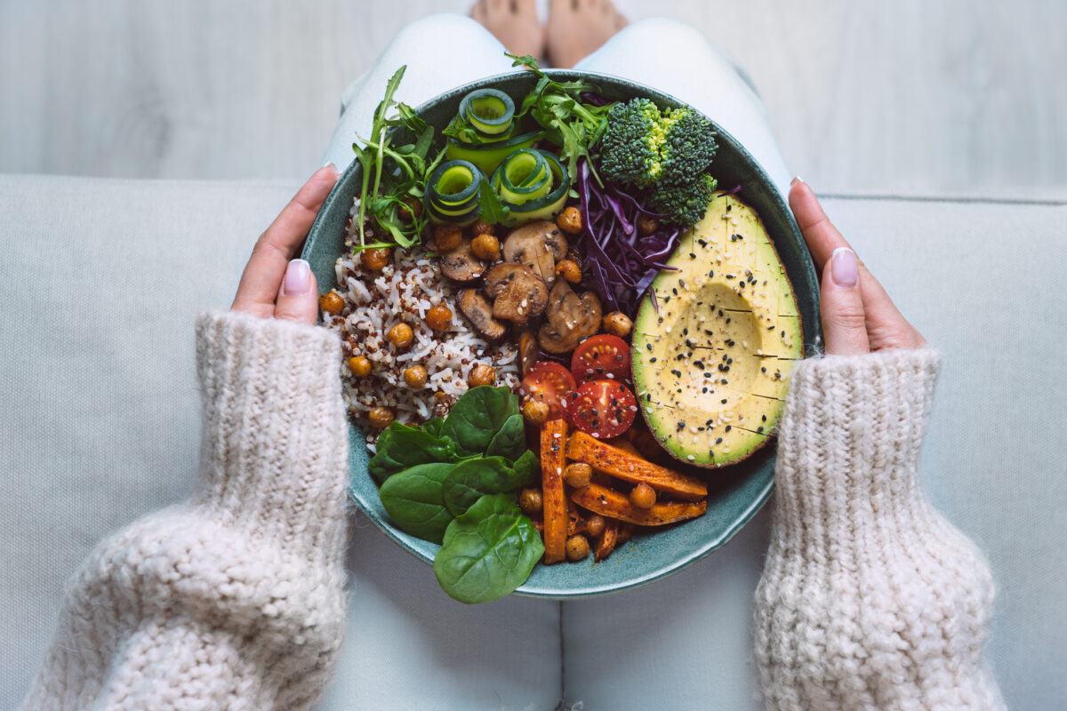 Healthy eating. Plate with vegan or vegetarian food in woman hands. Healthy plant based diet. Healthy dinner. Buddha bowl with fresh vegetables